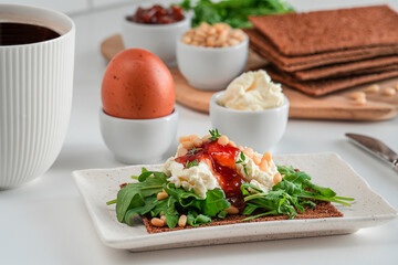 Healthy breakfast with egg, cup of coffee, crisp bread. 