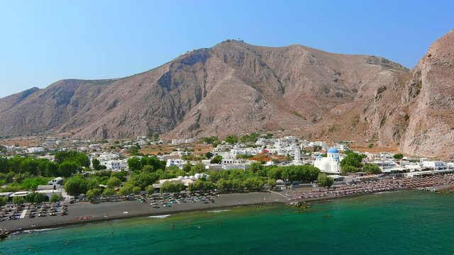 Santorini, Greece: Aerial view of Perissa, village with famous black sand beach Paralia Perissa on Santorini (Thira or Thera) island, Mediterranean Sea - landscape panorama of Europe from above