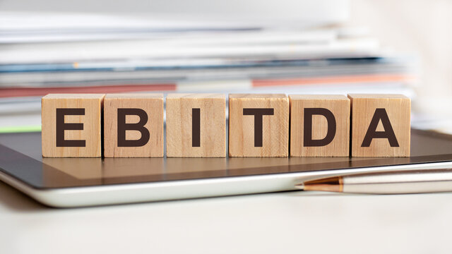 the word ebitda is written on wooden cubes, concept