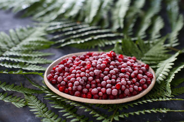 red  frozen cranberry berries on a textured background