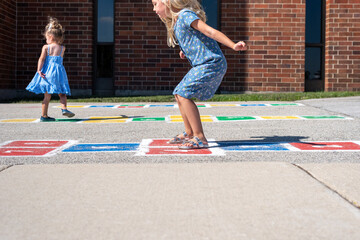 Kids playing hopscotch in the schoolyard