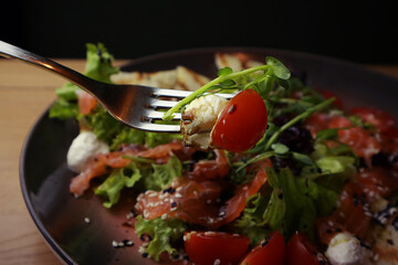Tasty salad with salmon , close up