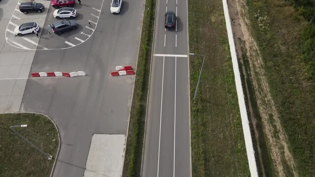 Aerial view of an new electric car doing a lap on the test track. Wide shot of electric car test-drive. Green energy concept.