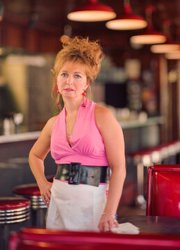 Portrait of waitress with big hair at old school diner