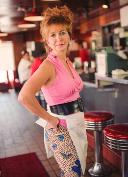 Portrait of waitress with big hair at old school diner