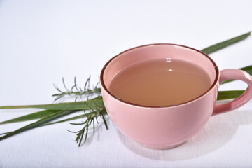 lemon grass green tea in pink cup isolated on white background