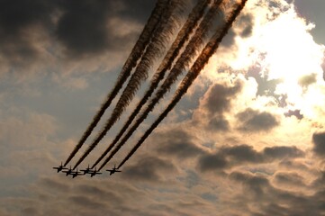 Silhouette of Blue Impulse against background of sunset sky