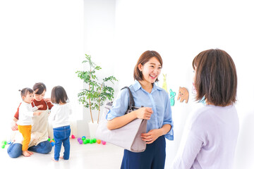 Fototapeta premium 幼稚園の送り迎えをするビジネスウーマン