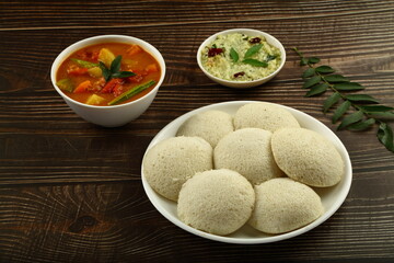 Tamilnadu foods- delicious idli, idly sambar and chutney served on a vintage table. healthy meal.