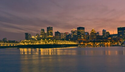 Montreal Downtown skyline during the sunset. Foreground is Saint Lawrence (Laurent) river.