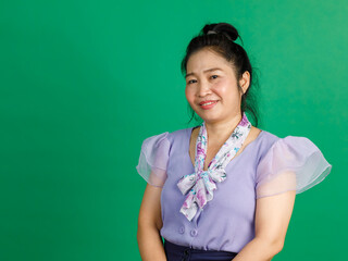 Studio portrait shot of Asian happy middle aged ponytail hairstyle woman in purple chiffon dress...