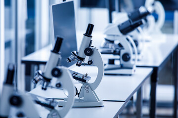 Close up shot of two eyes viewfinder scientific microscope in row of one eye microscopes line in...