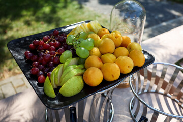 Fruit buffet in the square black tray. 