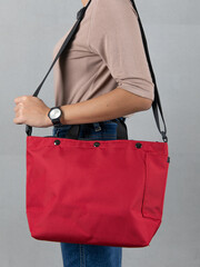 Isolated close up studio shot of female model in brown long sleeve shirt and jeans stand hanging...