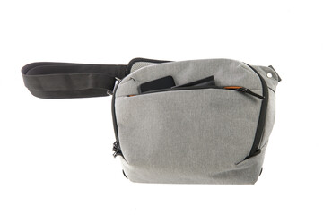 Isolated close up studio shot of small photographer modern fashionable gray shockproof waist bag...