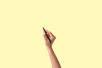 Woman with pen on color background