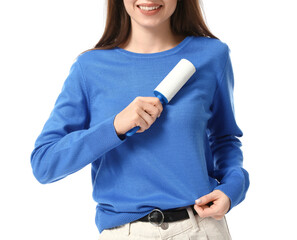 Young woman cleaning her sweater with lint roller on white background