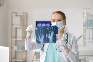 Female doctor with x-ray scan in clinic