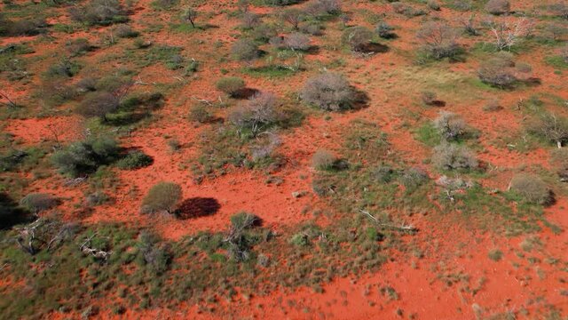 Red sand desert rugged scenic outback Australia cinematic aerial tilt shot