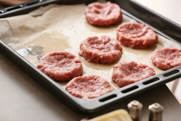 Baking tray with minced meat boats on table