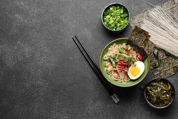 Composition with tasty Chinese soup on dark background