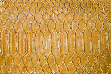 Fish-like scales with golden and shining colors. Abstract Background. Life-like textures in fashion, handbags and exclusive packaging cases for luxury items. © ysk1