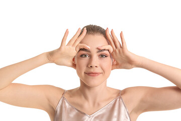 Beautiful young woman doing facial yoga on white background