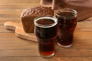 Glasses of fresh kvass on wooden background