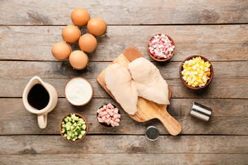 Different ingredients for okroshka on wooden background