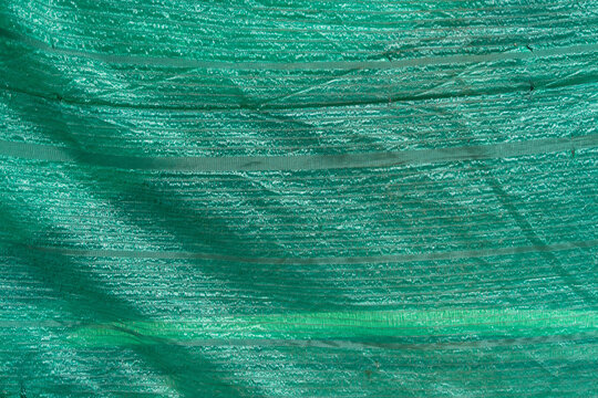 Green slan light filter or sun shade net. Light prevention. Covering. Construction site.