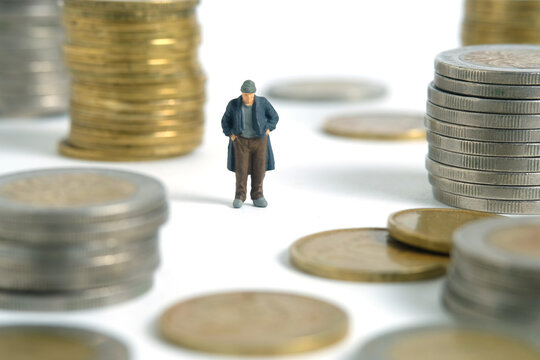 Miniature people toy figure photography. Bankruptcy concepts. A sad man with no money standing on coin stack money. Isolated on white background. Image photo