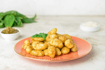 Plate with tasty pesto gnocchi on table