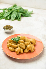 Plate with tasty pesto gnocchi on table