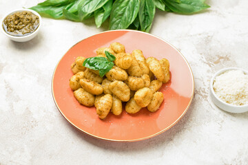 Plate with tasty pesto gnocchi on table