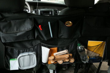 Travel organizer with different things on car seat, closeup