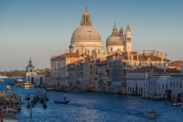 Fototapeta na wymiar Dome of the Cathedral of Santa Maria della Salute in the cityscape on a sunny September evening. Venice. Italy