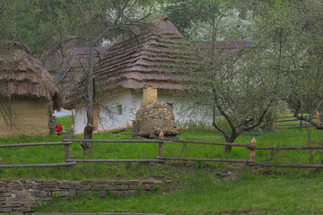 Kyiv. Ukraine - Traditional ukrainian old house with straw roof. National architecture. Warm spring...