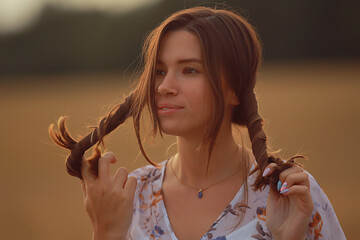 adult girl with two pigtails summer brunette, cheerful mood, funny