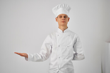 a man in a chef's uniform gesturing with his hand work professional cooking