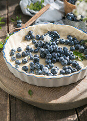 Homemade pastry blueberry  pie pies bakery products on dark wooden kitchen table . Traditional dessert on Independence Day. Flat lay food background. Top view