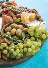 Antipasto background. Different Italian snacks with fruit, nut on a rustic background.