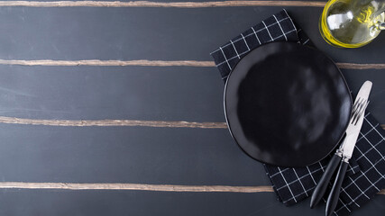 Empty plate with fork and knife. Top view, text space
