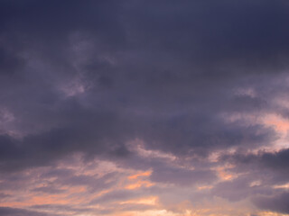 Naklejka na ściany i meble Colored clouds in the sunset sky.