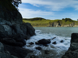 Fototapeta premium Tide wave on rocky shore.