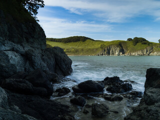 Tide wave on rocky shore.