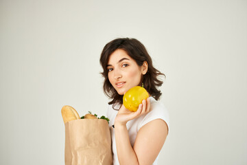 cute brunette in white t-shirt package with healthy food products