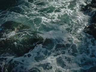 Tide wave on the rocky beach.