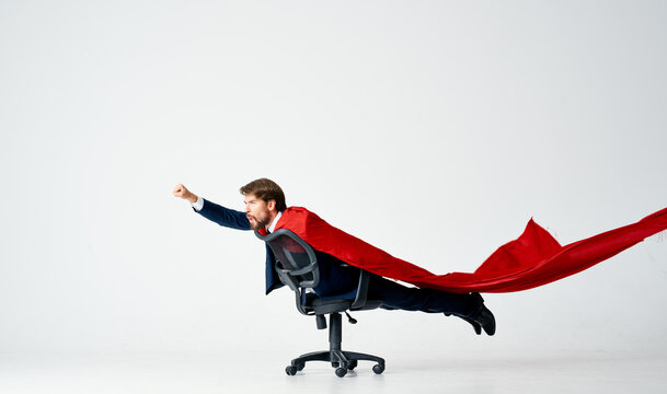 business man in suit office chair red cloak superhero