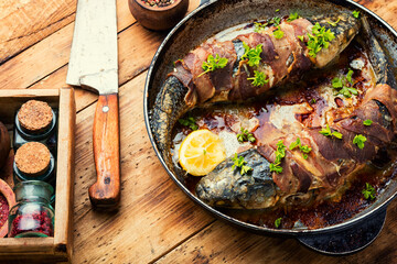 Baked fish wrapped in bacon