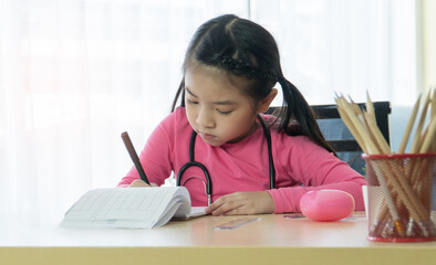 children girl learning homework drawing at home.